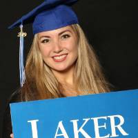 blonde student holding laker sign